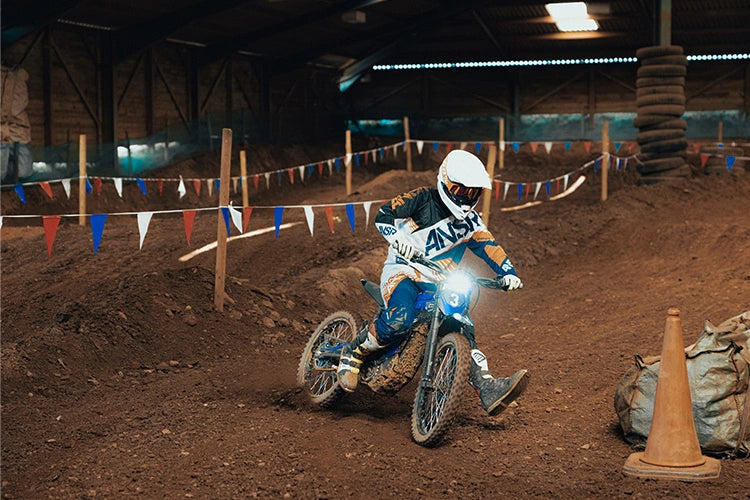 Electric dirt bike on grassy farm track - outdoor adventure